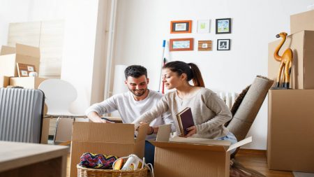 Couple packing moving boxes