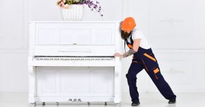 Man moving a piano