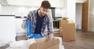 young man packing a kitchen