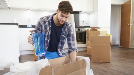 young man packing a kitchen