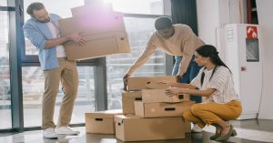 Office workers moving boxes