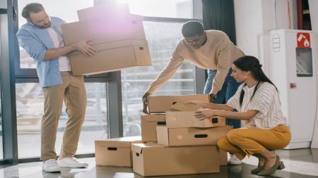 Office workers moving boxes